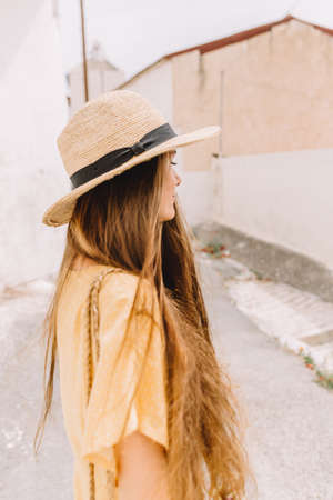 portrait of a girl in a straw hat and in the summer in Mediterranean, on vacation