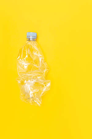 Used plastic bottle for recycling, on a yellow background, conceptual image with copy spaceの写真素材