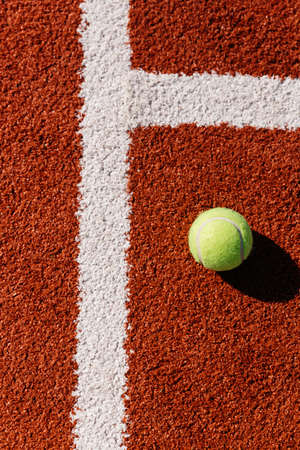 Yellow tennis ball on the tennis court.の写真素材