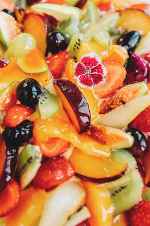 Cake with fruits isolated on white background, top view. Strawberry and pear, fig and grapes, plum and peach.の写真素材