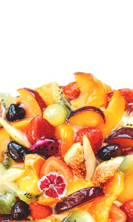 Cake with fruits isolated on white background, top view. Strawberry and pear, fig and grapes, plum and peach.の写真素材