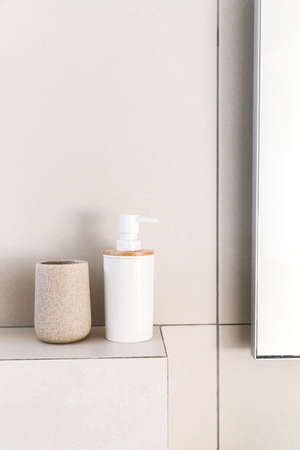 Beige jars for bathroom. Cosmetic accessories on shelf bathroom.の写真素材