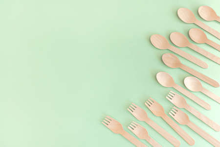 Bamboo wooden spoons and forks on mint background. Top view and flat lay. No plastic concept. Zero waste lifestyle.の写真素材