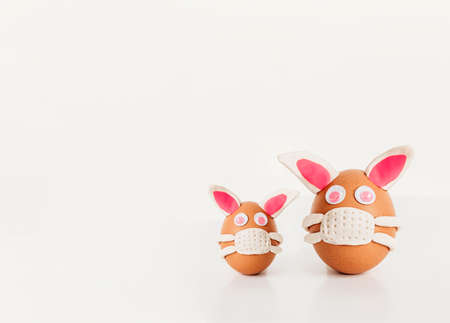 Easter egg bunny with  virus  . Easter egg bunny wearing mask. Easter decoration. Selective focus, copy space.  protection concept.の写真素材