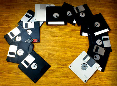 Old Diskettes scatter on the wood floor.の写真素材