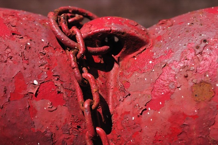 Part of water diffuser with the rusted red chainの写真素材