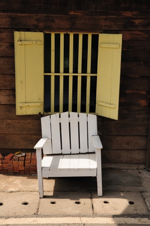 White chair in front of the opened windows の写真素材