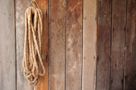 Brown string hanging on wooden wallの写真素材