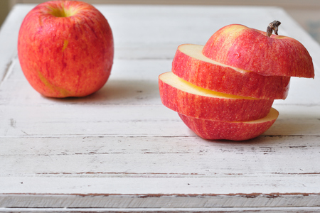 Red slide apples on wooden table の写真素材