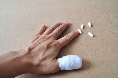Man hand with thumb bandage の写真素材