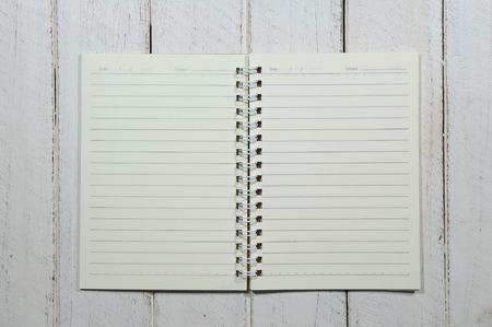 Small paper notebook on wooden table.の写真素材