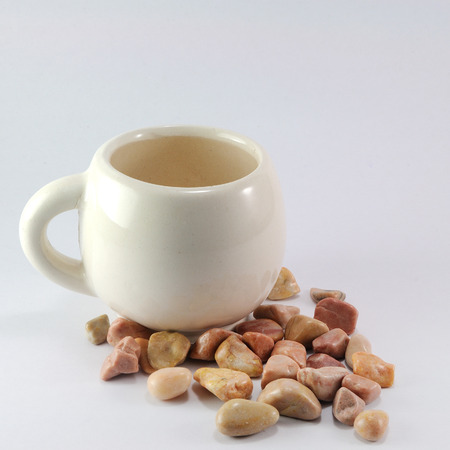 Small coffee-cup near rocks, conception.の写真素材
