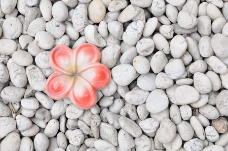 Ceramic flower on white rock, pattern and background.の写真素材