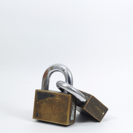 Double padlocks with key on white background.の写真素材