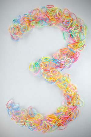 Number 3 from elastics hair-band with vignette frame.