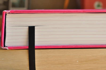 Big book use black bookmark ribbin putting on shelf