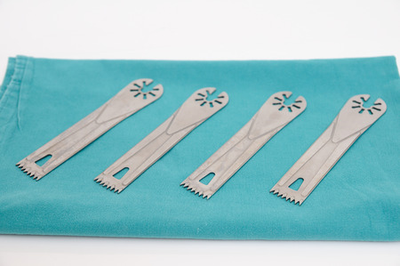 Surgery oscillating saw blades on green cloth.