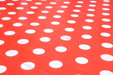 White spots on red floor for background.の写真素材