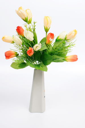 Red flowers in white flower pot, artificiallyの写真素材