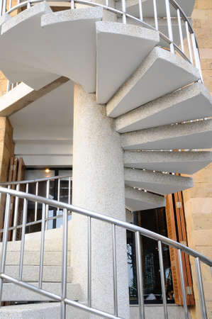 White winder stairs with stainless steel handrail