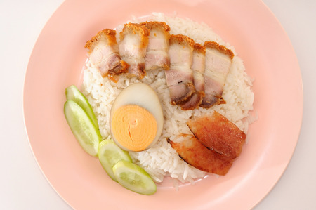 Crispy pork rice and half of egg with sauceの写真素材