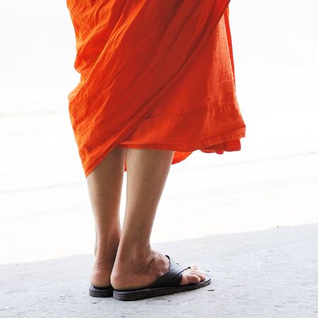 Single Thai monk standing on roadの写真素材