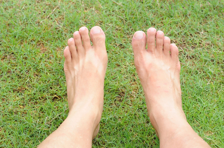 Man legs relaxation on green grass