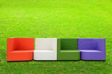 Colorful artificial rattan sofa beside green yardの写真素材