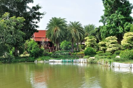 Thai Classic house next to lake in public garden.の写真素材