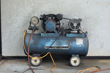 Dirty Mini electric pump next to grunge wallの写真素材