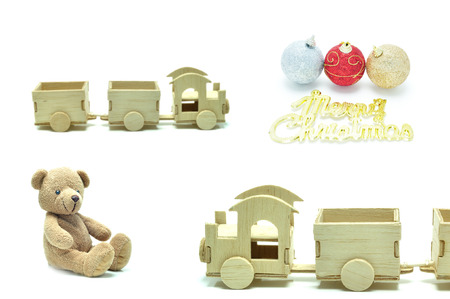 Wooden train teddy bear and Christmas balls, festival popular gifts on white background.の写真素材