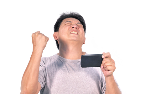 Middle Asian man 42 years old surprise happy exciting with smart phone, human behavior concept.