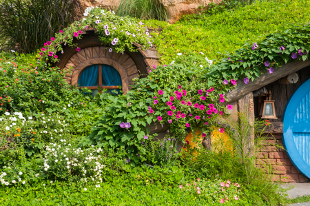 Beautiful garden with flowers and nice hut.の写真素材
