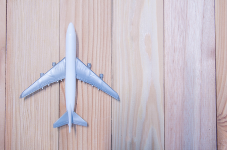 Top view, miniature part of plastic airplane on wooden table.の写真素材