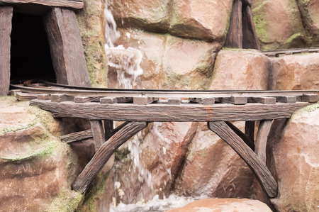 Train track of mine next to rock mountain.の写真素材