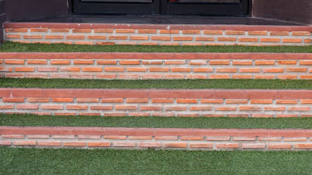 Red brick block stair with green grassesの写真素材