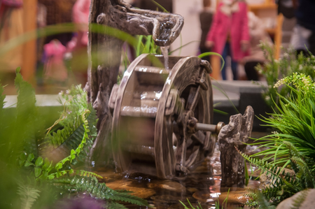 Selective focus miniature of wooden Water-wheels and small garden.の写真素材