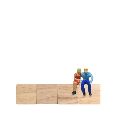 Selective focus miniature male and female couple lover sitting together saying something, family lover concept.の写真素材