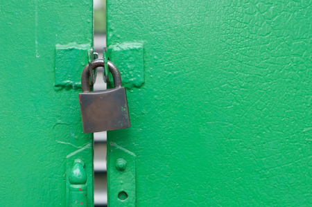 Green gate be locked by old and grunge padlock. copy space on right.の写真素材
