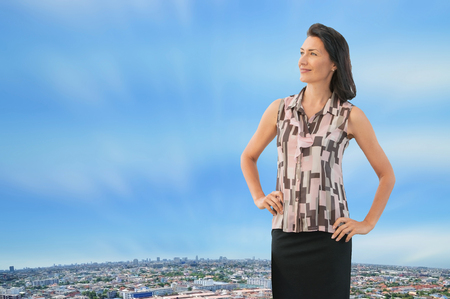 Middle aged professional business woman acting in big city backgroundの写真素材