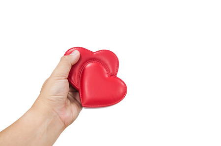 Man hand holding red leather heart isolated with clipping path, valentine couple love concept.の写真素材