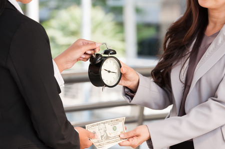 Unidentified business people use dollar bank note buy the time from other people, business concept time managing.の写真素材