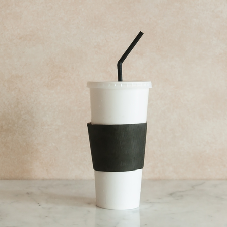 Paper ice coffee mug on marble table with texture background.の写真素材
