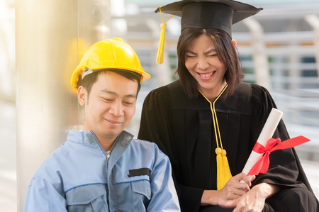 Happy nice couple lover, engineer and fresh graduated girlfriend talking something about work career.の写真素材