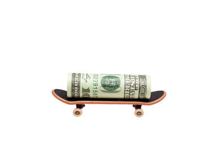 Money transaction concept, dollar banknote on skateboard isolated
