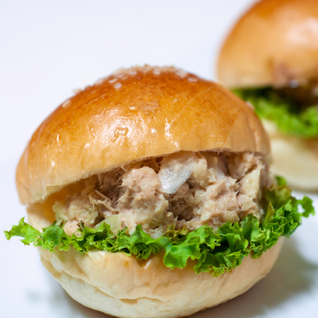 Mini tuna hamburgers with green vegetable, fast food meal.の写真素材