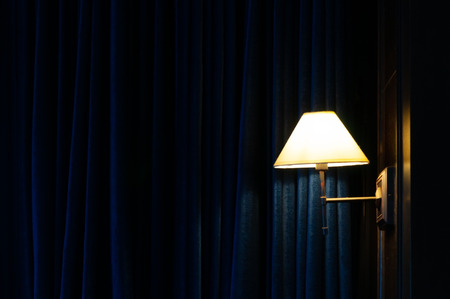 Luxury vintage single hanging lamp with dark blue curtain, house interior design retro concept.の写真素材