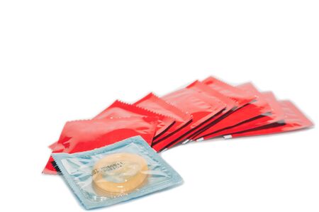 Stack of red condom package on white background, preventive safe sex.  Health conception.の写真素材