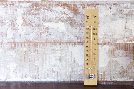Classic and Vintage thermometer leaning with vintage wooden wall.の写真素材