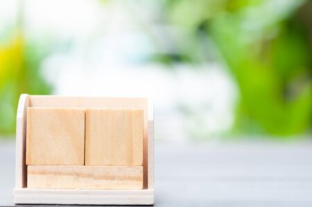 Close up empty cube boxes on wooden table and blur background.